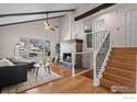 Living room featuring hardwood floors, a fireplace, and staircase at 2132 Ridge Dr, Broomfield, CO 80020