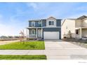 Two-story home with gray and beige siding, landscaping, and a two-car garage at 2245 Base St, Fort Lupton, CO 80621