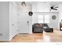 Bright entryway with hardwood floors, leading to living room at 257 Jackson Dr, Erie, CO 80516