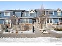 Two-story townhome with blue siding, white trim, and a fenced front yard at 257 Jackson Dr, Erie, CO 80516