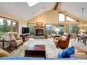 Inviting living room features stone fireplace, vaulted ceilings, and mountain views at 302 Deer Trail Cir, Boulder, CO 80302