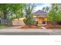 Charming yellow house with landscaped yard and detached garage at 350 Florence Ave, Firestone, CO 80520