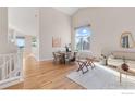 Bright living room featuring hardwood floors, high ceilings, and a large window with views at 440 Andrew Way, Superior, CO 80027