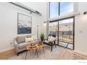 Cozy living room with stylish decor, a large window for natural light, and access to an outdoor balcony with scenic views at 4645 Broadway St # C-1, Boulder, CO 80304