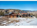 Exterior view of a two-car garage with a stunning mountain backdrop at 515 Indian Mountain Rd, Longmont, CO 80503