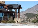 Stone and wood exterior detail with mountain views in the background at 515 Indian Mountain Rd, Longmont, CO 80503