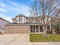 Two-story house with a two-car garage and a manicured lawn at 5508 Triple Crown Dr, Frederick, CO 80504