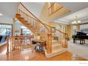 Elegant curved staircase with wooden railings, leading to upper level at 5508 Triple Crown Dr, Frederick, CO 80504