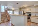 Modern kitchen with stainless steel appliances and breakfast bar at 5690 W 80Th Pl # 91, Arvada, CO 80003