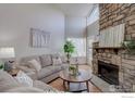 Bright living room with hardwood floors and a cozy fireplace at 5690 W 80Th Pl # 91, Arvada, CO 80003