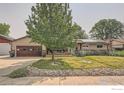 Charming ranch home with a landscaped yard, and a large driveway at 616 S Carr Ave, Lafayette, CO 80026