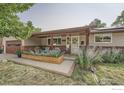 Inviting front porch with wooden posts,planters, and comfortable seating area at 616 S Carr Ave, Lafayette, CO 80026