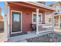 Inviting front porch features stylish decor, decorative rock landscaping, and a welcoming entrance at 673 Country Road N Trl, Berthoud, CO 80513