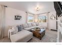 Comfortable living room featuring a large sectional sofa, and an accent rug at 673 Country Road N Trl, Berthoud, CO 80513