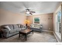 Cozy living room featuring comfortable seating and a bright window at 719 Marshall Pl, Berthoud, CO 80513