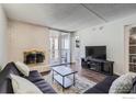 Living room with hardwood floors, fireplace, and sliding door to balcony at 805 29Th St # 405, Boulder, CO 80303