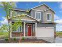 Two-story house with gray siding, red door, landscaping, and a two-car garage at 824 Ledge St, Lochbuie, CO 80603