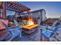 Backyard patio with fire pit and seating area at 864 Dakota Ln, Erie, CO 80516