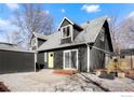 This backyard features a stone patio and a comfortable outdoor seating area at 125 Telluride Pl, Longmont, CO 80504