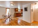 Basement dining area with hardwood floors, dining table, and adjacent kitchenette at 1342 Milwaukee St # 5, Denver, CO 80206