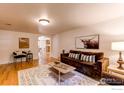 Inviting living room featuring a comfortable brown sofa and stylish décor with hardwood flooring at 1342 Milwaukee St # 5, Denver, CO 80206