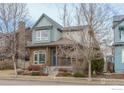 Two-story craftsman style home with a metal roof and stone accents at 1345 Snowberry Ln, Louisville, CO 80027