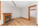 Hardwood floors, fireplace, and view into another room at 1430 18Th St # 1, Boulder, CO 80302