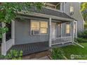 Front porch with white railings and gray flooring at 1430 18Th St # 1, Boulder, CO 80302