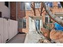 Brick front exterior featuring a light blue front door and black metal railing at 154 S Jackson St, Denver, CO 80209