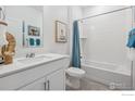 Clean bathroom with white vanity, bathtub, and grey tile floor at 1866 Westport Ave, Berthoud, CO 80513