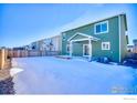 Large backyard with a deck and a snow-covered lawn at 2251 Kerry St, Mead, CO 80542