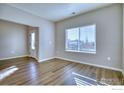 Living room with hardwood floors and large windows at 2251 Kerry St, Mead, CO 80542