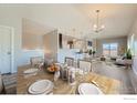 Bright dining room with a view of the living room and kitchen at 2417 Calais Dr # G, Longmont, CO 80504