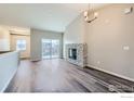 Living room featuring hardwood floors and a stone fireplace at 2435 Calais Dr # I, Longmont, CO 80504