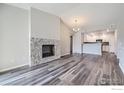 Living area with hardwood floors and stone fireplace at 2435 Calais Dr # I, Longmont, CO 80504