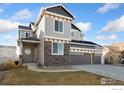 Charming two-story home with stone accents, a covered front porch, and a three-car garage at 2483 Tabor St, Berthoud, CO 80513