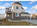 Charming two-story home featuring a three-car garage and a welcoming front porch at 2483 Tabor St, Berthoud, CO 80513