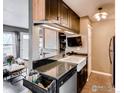 Modern kitchen with stainless steel appliances, a farmhouse sink, and granite countertops at 3025 Broadway St # 40, Boulder, CO 80304