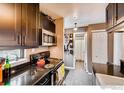 The modern kitchen offers sleek dark cabinets, stainless steel appliances, and granite countertops at 3025 Broadway St # 40, Boulder, CO 80304