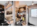 Modern kitchen with stainless steel appliances, dark cabinets and granite countertops, next to a door to the exterior at 3025 Broadway St # 40, Boulder, CO 80304