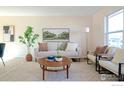 Bright living room with light walls and comfy seating at 402 Baron Ave, Lafayette, CO 80026