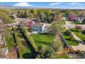 Expansive backyard with a manicured lawn, enclosed by a wooden fence, and a charming patio perfect for outdoor entertaining at 4302 Apple Way, Boulder, CO 80301