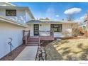 Inviting front porch with a wooden deck and landscaped walkway at 4667 Harwich St, Boulder, CO 80301