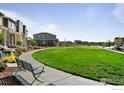 Common area with grassy lawn and bench at 5335 Spalding Pl, Frederick, CO 80504