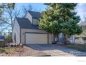 Two-story home with attached two-car garage and a long driveway for additional parking at 538 W Spruce Way, Louisville, CO 80027