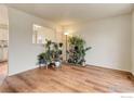 Bright living room with hardwood floors, neutral paint, abundant natural light, and stylish decor at 614 Glenwood Dr, Lafayette, CO 80026