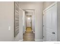 Bright and spacious entryway with wood-look floors and decorative wall art at 847 Ledge St, Lochbuie, CO 80603