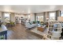 Open floor plan living room with hardwood floors and modern decor at 847 Ledge St, Lochbuie, CO 80603