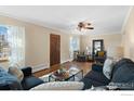 Inviting living room featuring hardwood floors, comfortable seating, and a ceiling fan at 860 S Garrison St, Lakewood, CO 80226