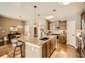 Spacious kitchen features a large island with seating and wooden cabinets at 1379 Charles Dr # 4, Longmont, CO 80503